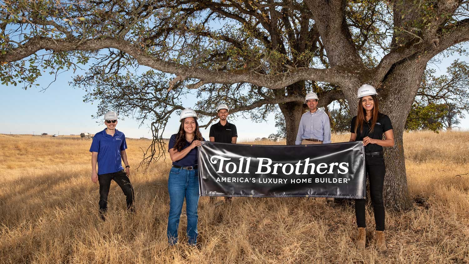 Toll Brothers employees with a Toll flag