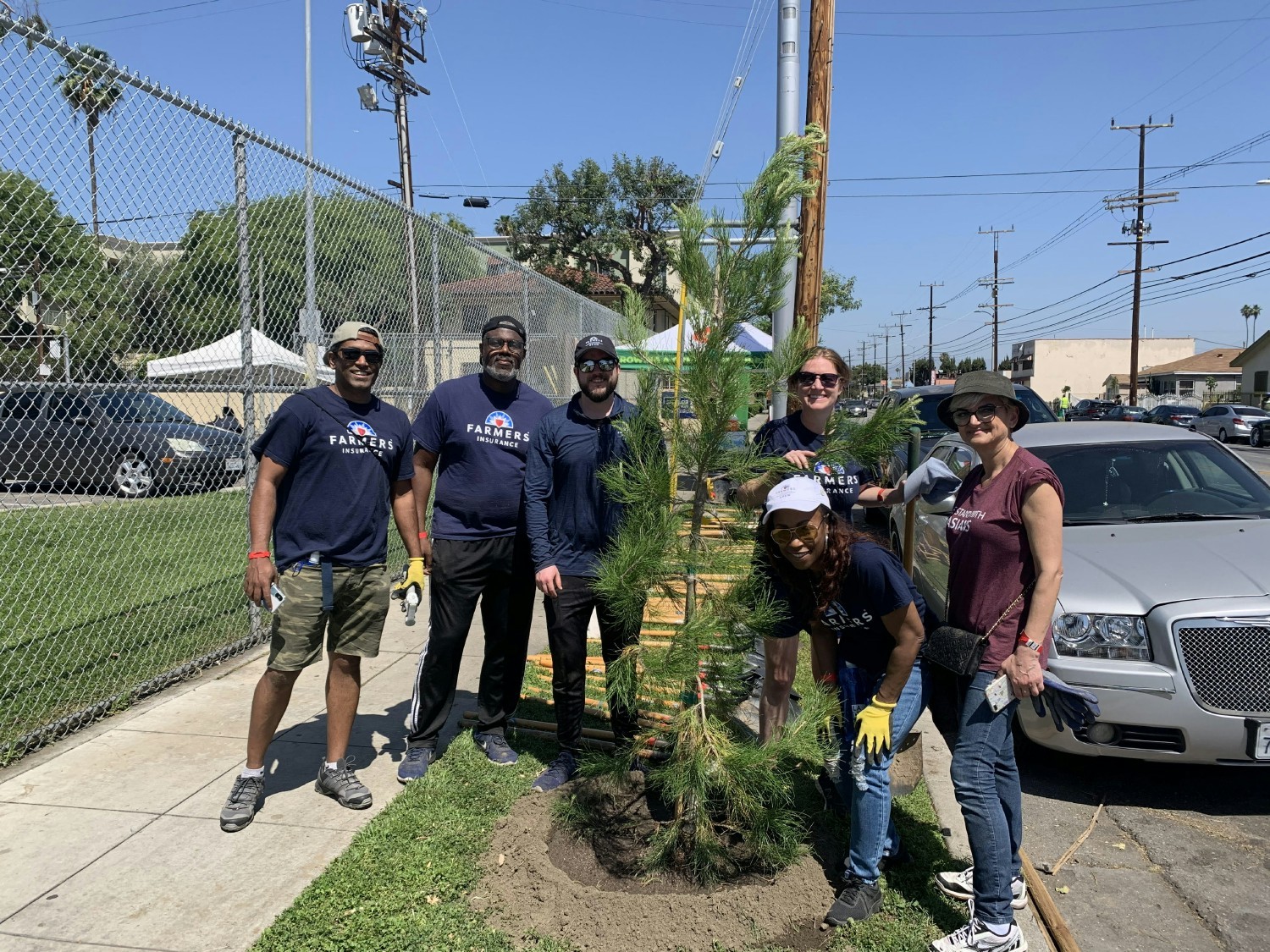 A group of Farmers ® employee volunteers planted new trees in a local community as part of our sustainability efforts.