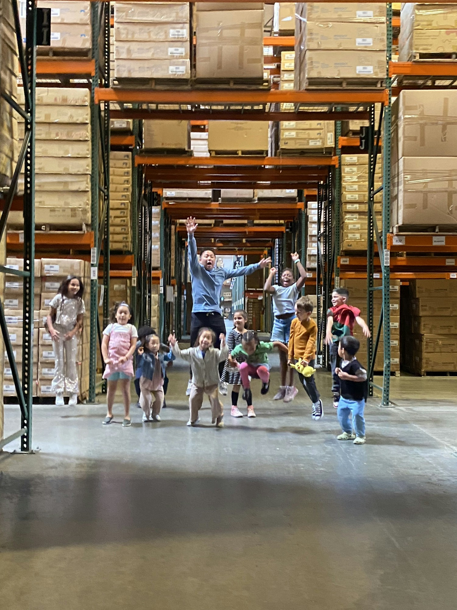 CEO Teddy Fong gives the kiddos a warehouse tour during 