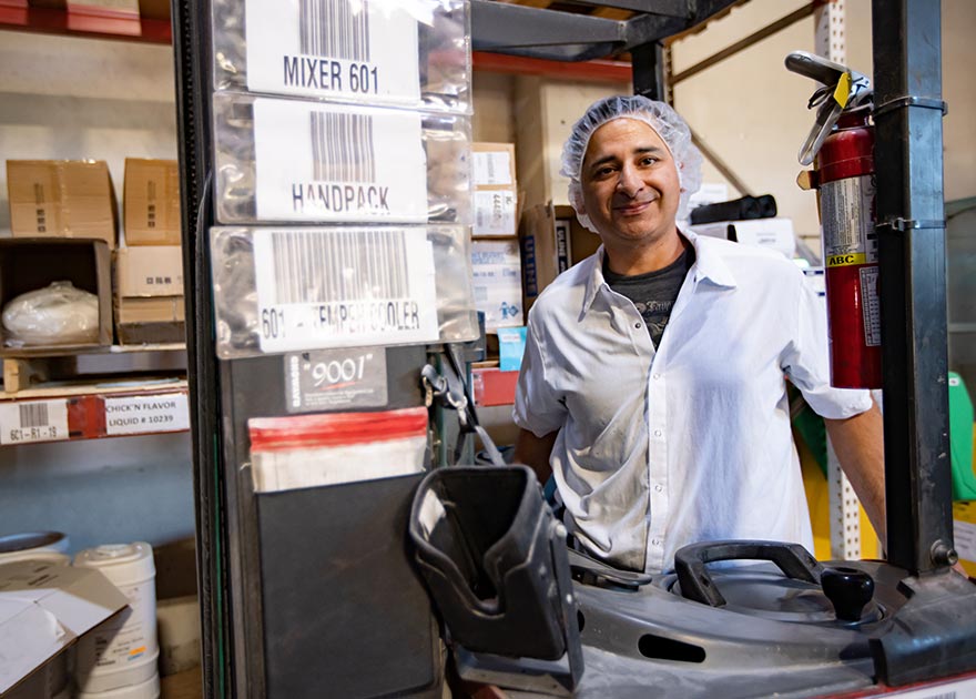 Warehouse employee at Tofurky smiles at the camera