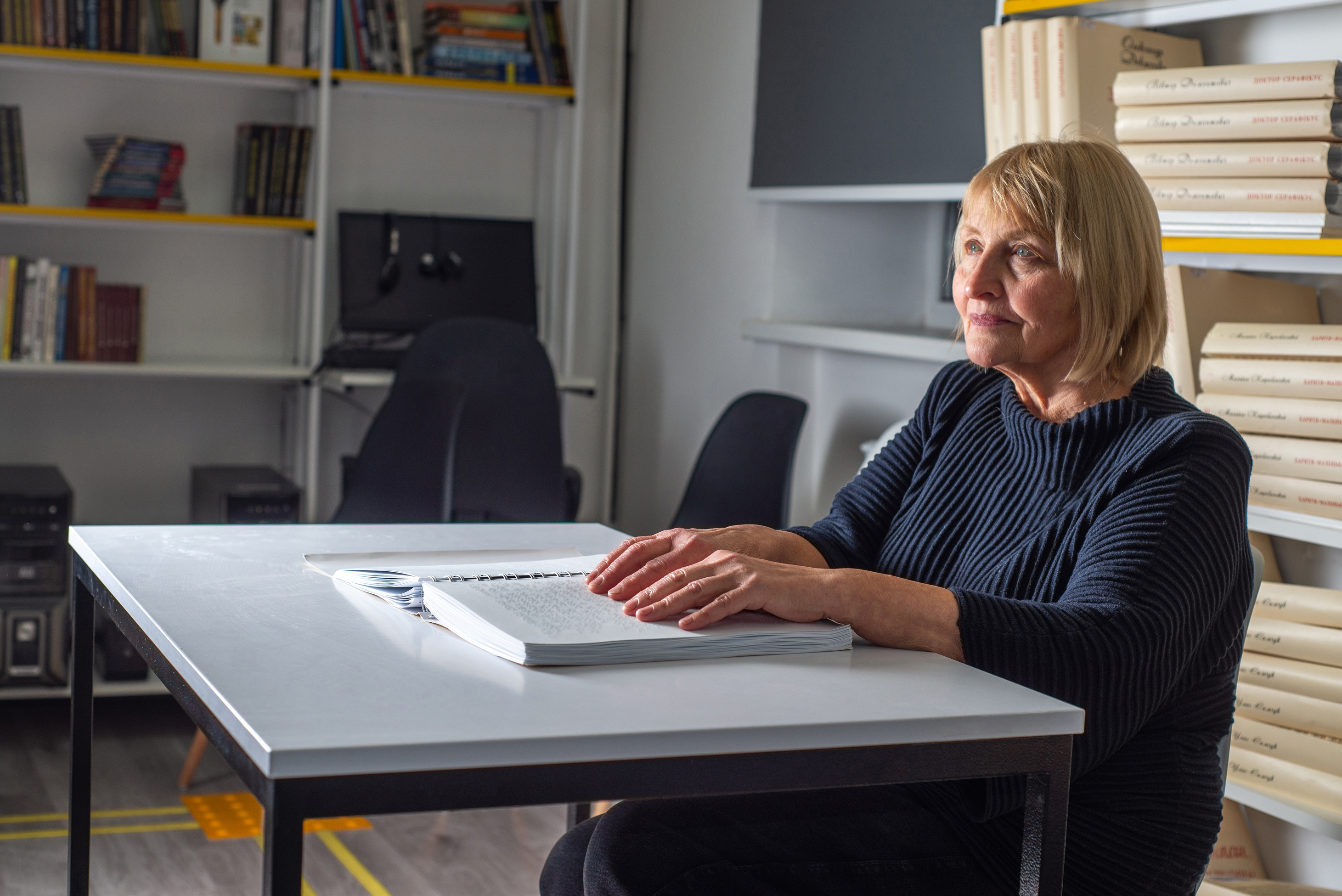  Visually impaired woman reading braille