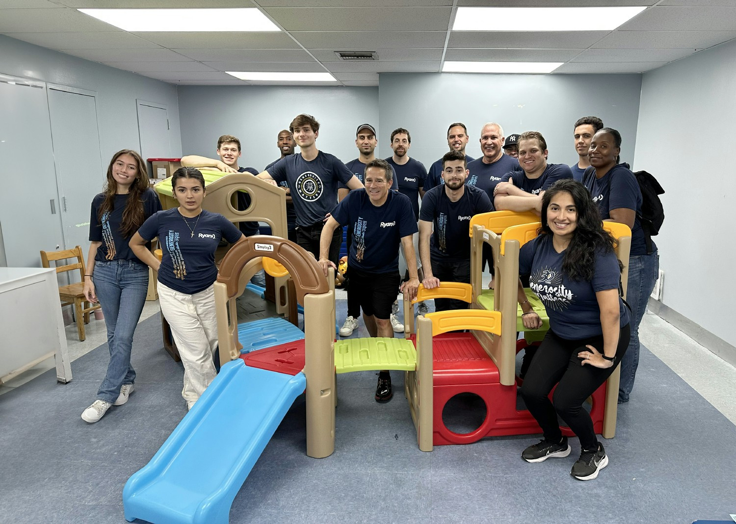 New York team members volunteer to assemble playground equipment for University Settlement’s Children’s Corner.