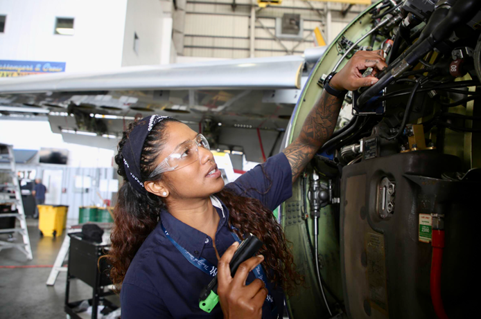 An AAR technician inspecting an aircraft in an AAR hangar. 