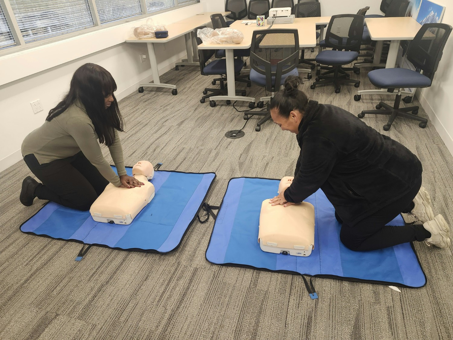 Employees practice CPR, showing Schmersal’s commitment to employee safety and emergency preparedness training.