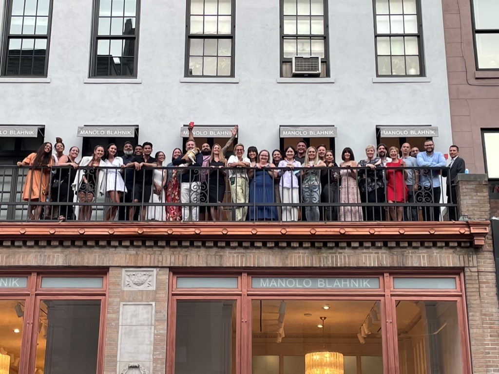 Our Manolo Blahnik Americas team waving from the balcony of our New York Office.