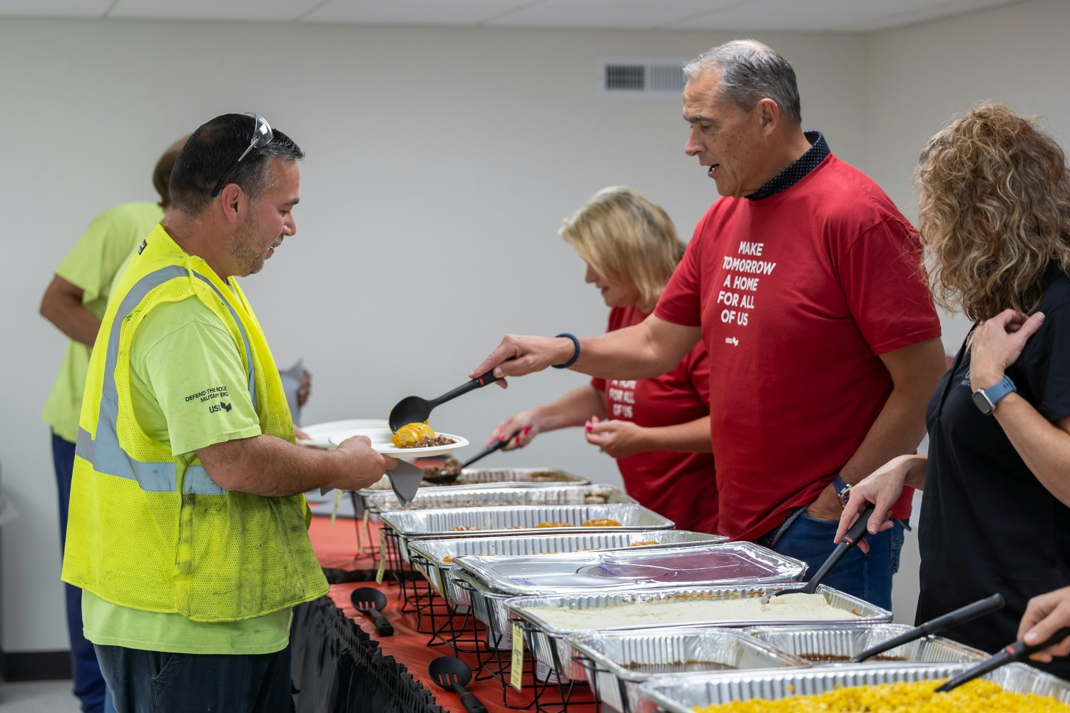 USG’s Leadership Team values servant leadership and is seen here serving meals to shift workers during a plant visit.