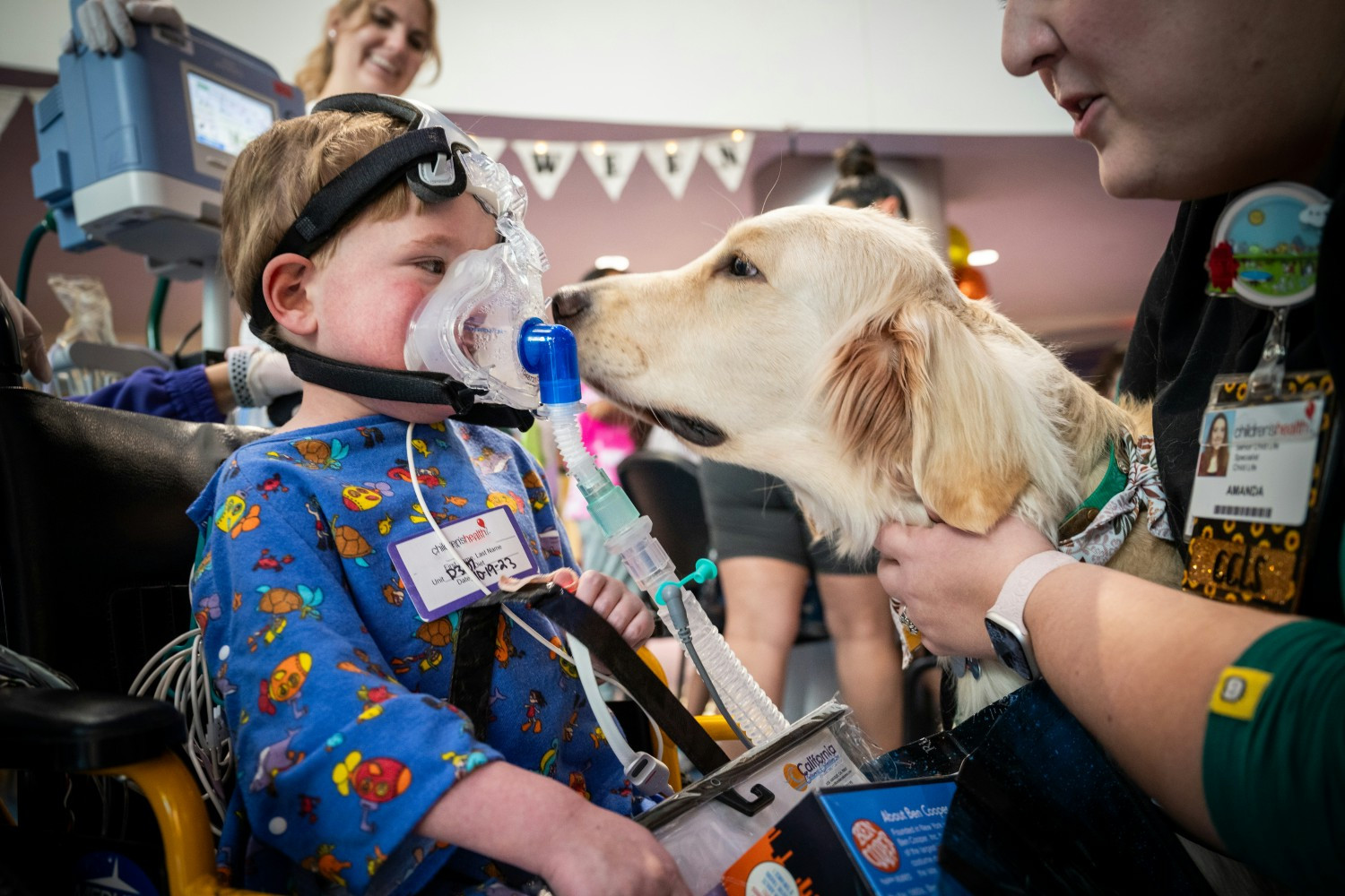 Our patient gets a smooch from Rex the Therapy Dog at our annual Patient Halloween Party.