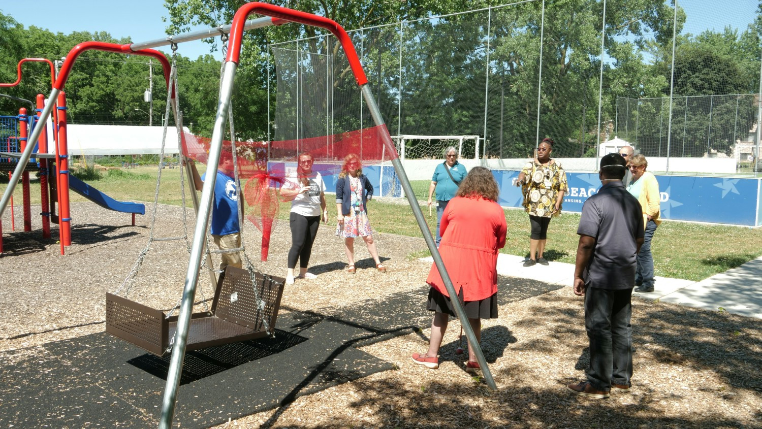 With the City of Lansing, Peckham helped build an accessible park, including the wheelchair swing pictured
