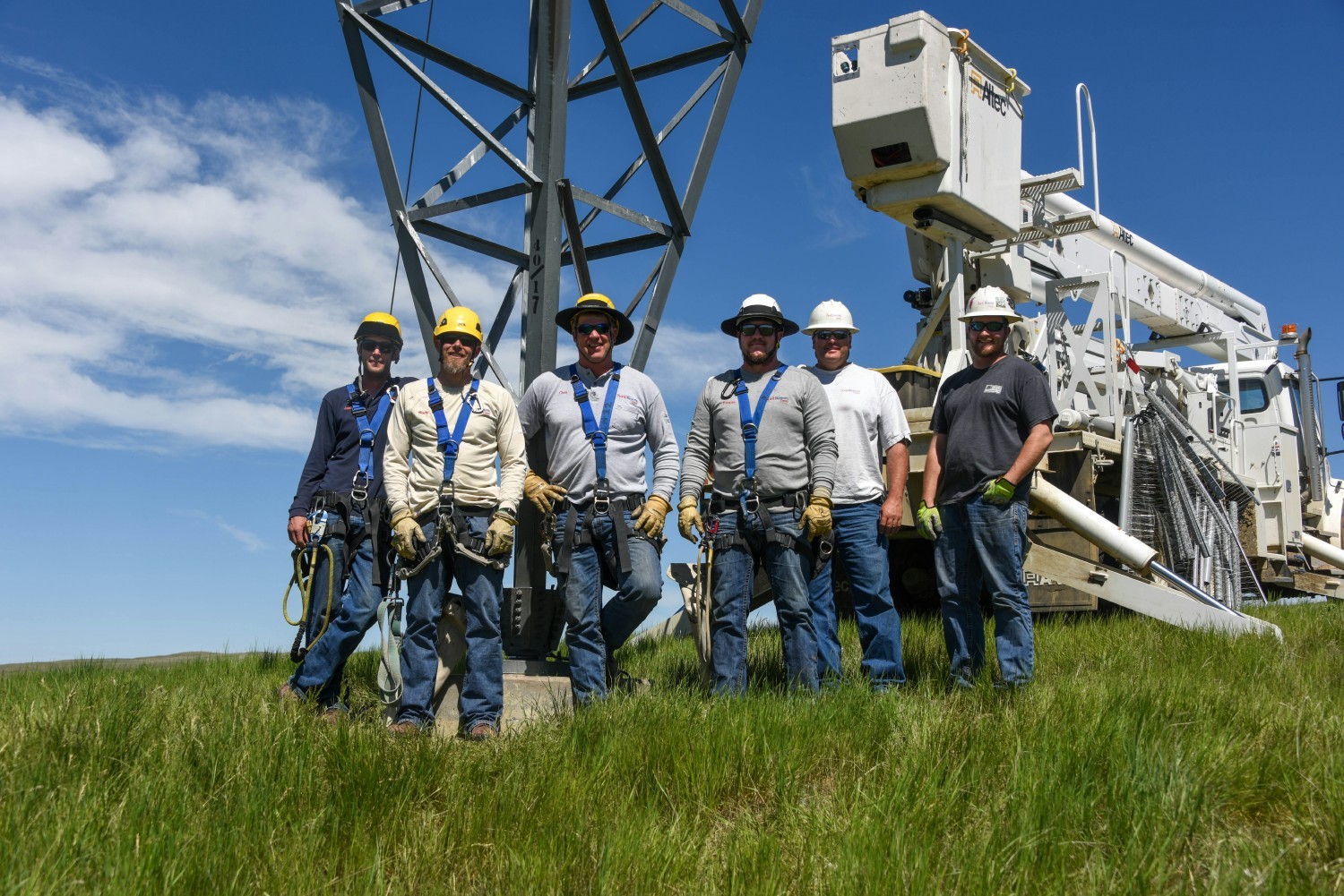 A group of line workers prepares to install bird deterrents on a power line in central Montana.