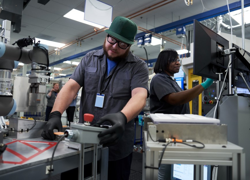 Colleagues collaborating to build and assemble healthcare technology on our Waukesha, WI manufacturing line.