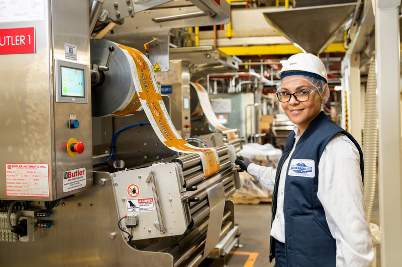 Ilda inspects bagging equipment. Our awesome production team makes sure our chocolate is made to our high standards.