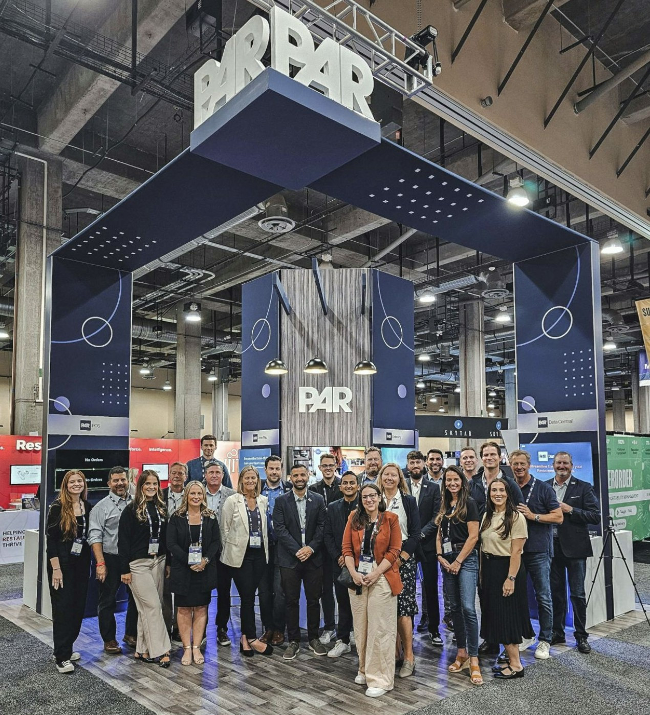 PAR employees bonding at a conference booth