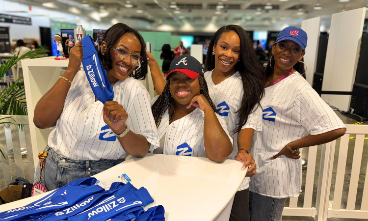 Employees share swag while networking with top talent at RenderATL, a tech conference in Atlanta, GA.