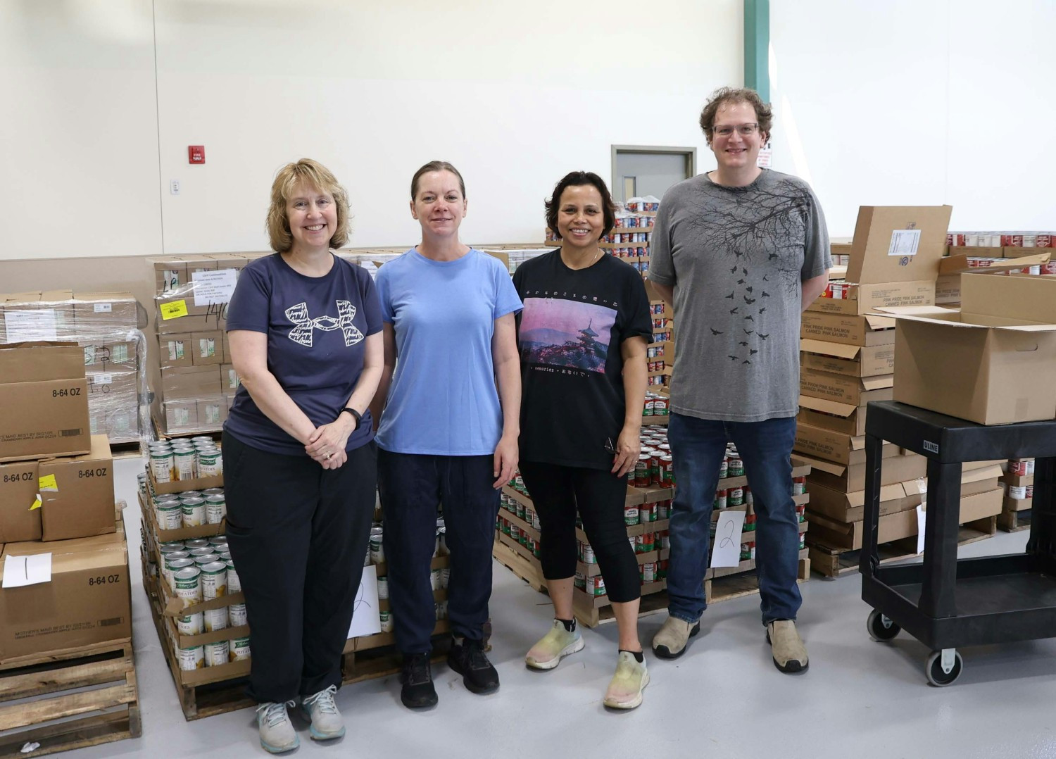 Employees volunteering at the Rhode Island Food Bank as part of AIPSO's community service program