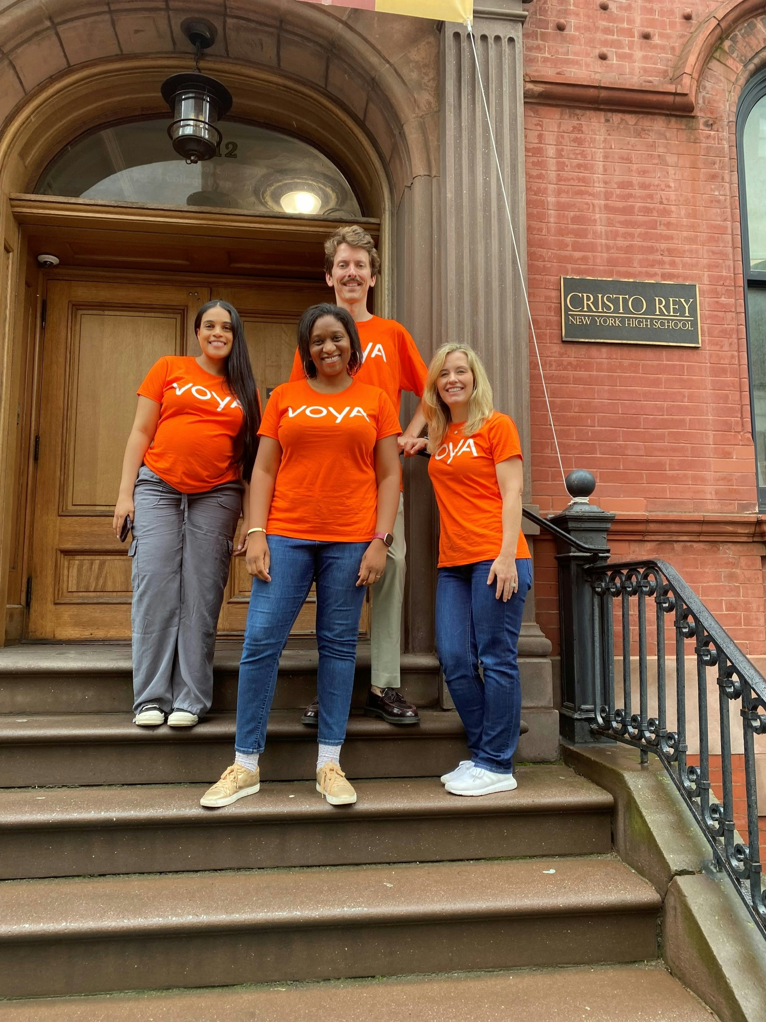 Employees volunteering at Cristo Rey New York High School, teaching financial literacy.