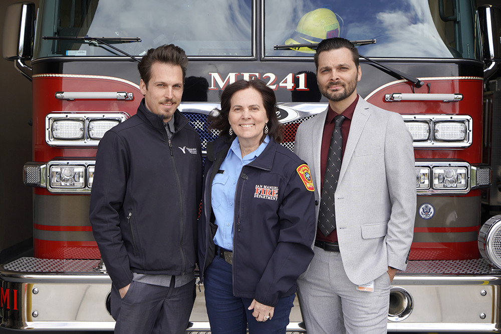 San Manuel Fire Department's Ann Coyle, middle, poses with her sons Daniel and Martin, who also work for the enterprise.