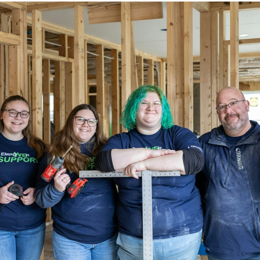 Staff posing for a picture after participating in our Syracuse Habitat for Humanity build project.