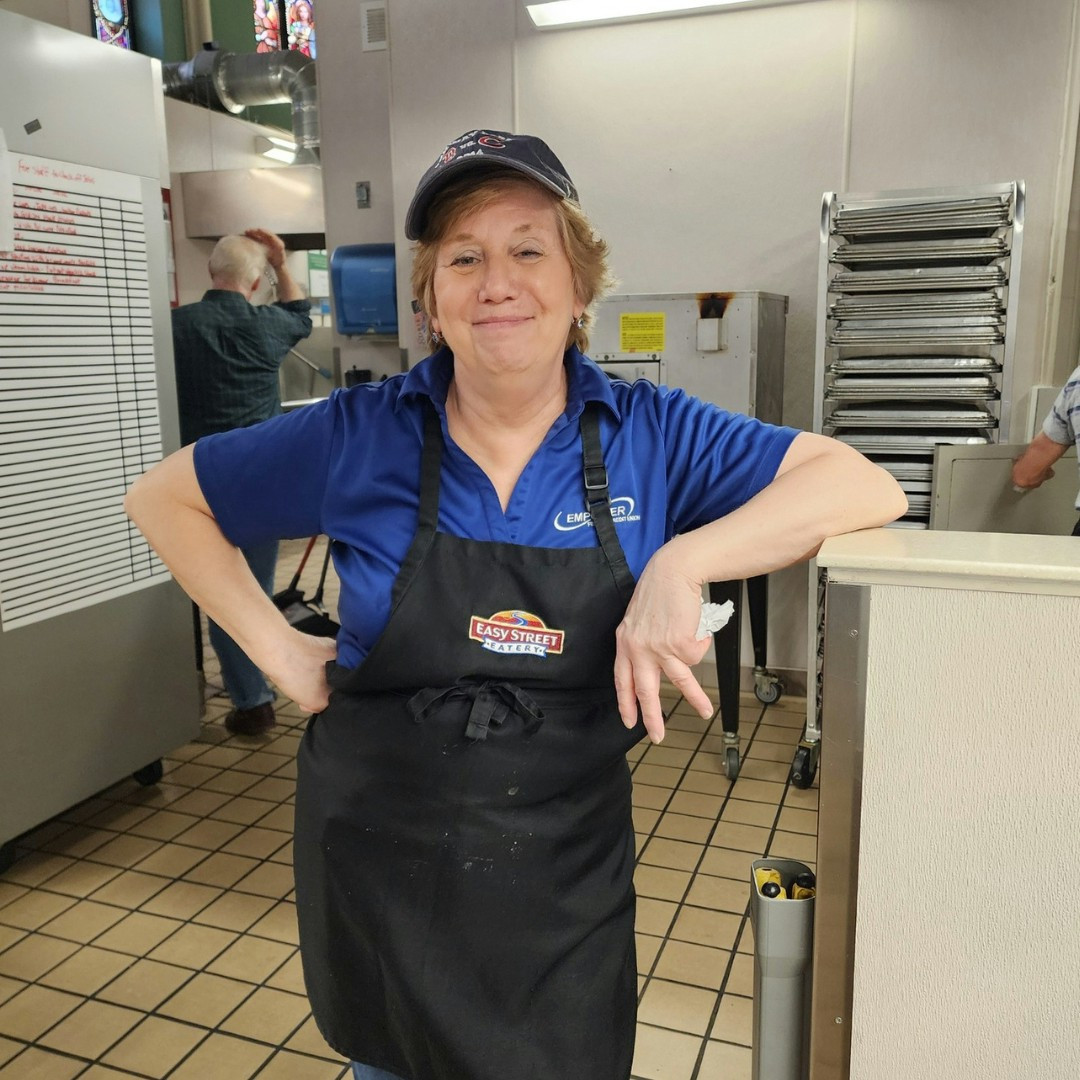 Putting community first, our staff volunteers at the Samaritan Center serving meals. 