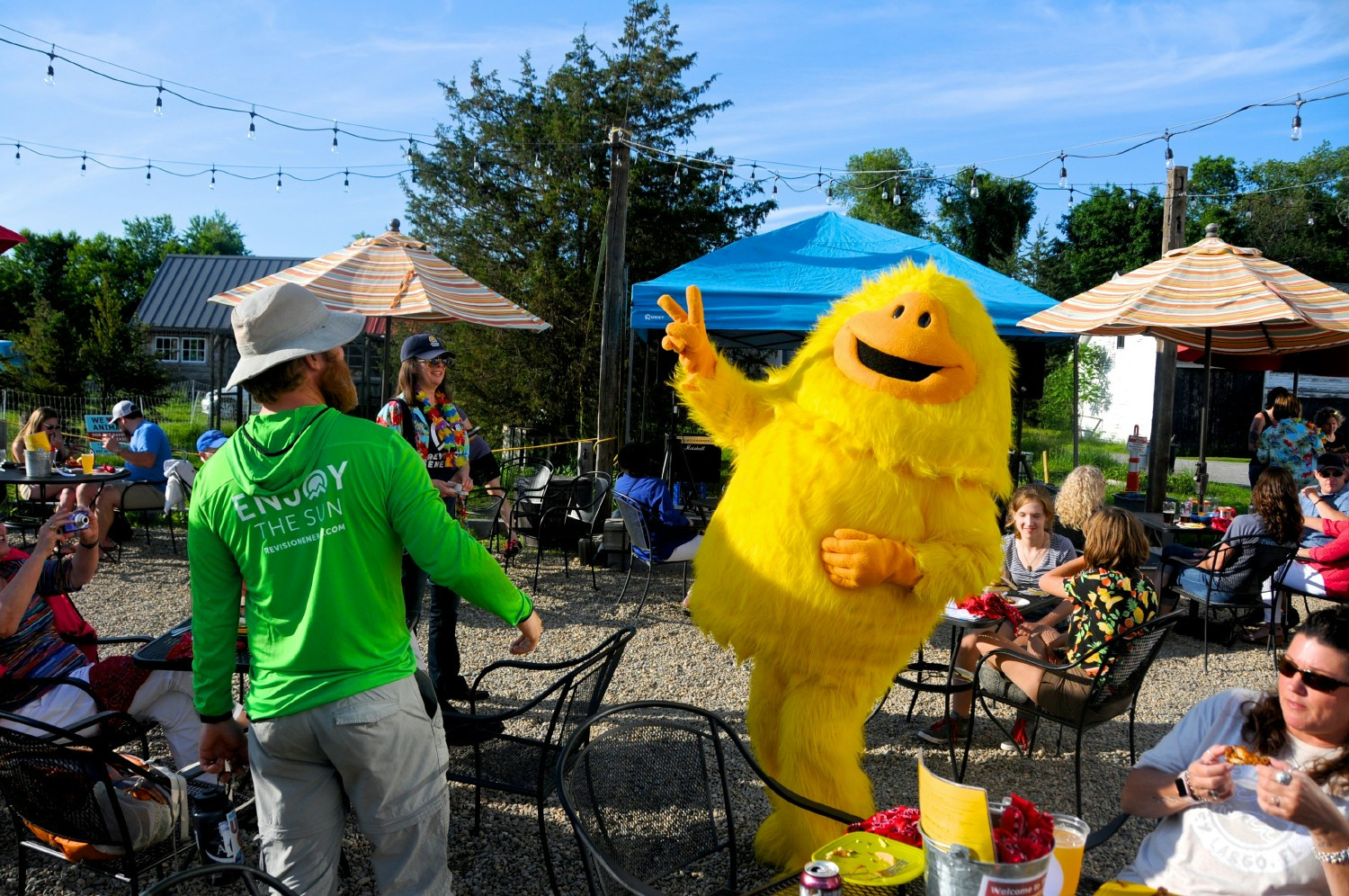 ReVision's mascot Sunsquatch along with team members enjoy some fun in the sun at a summer event 