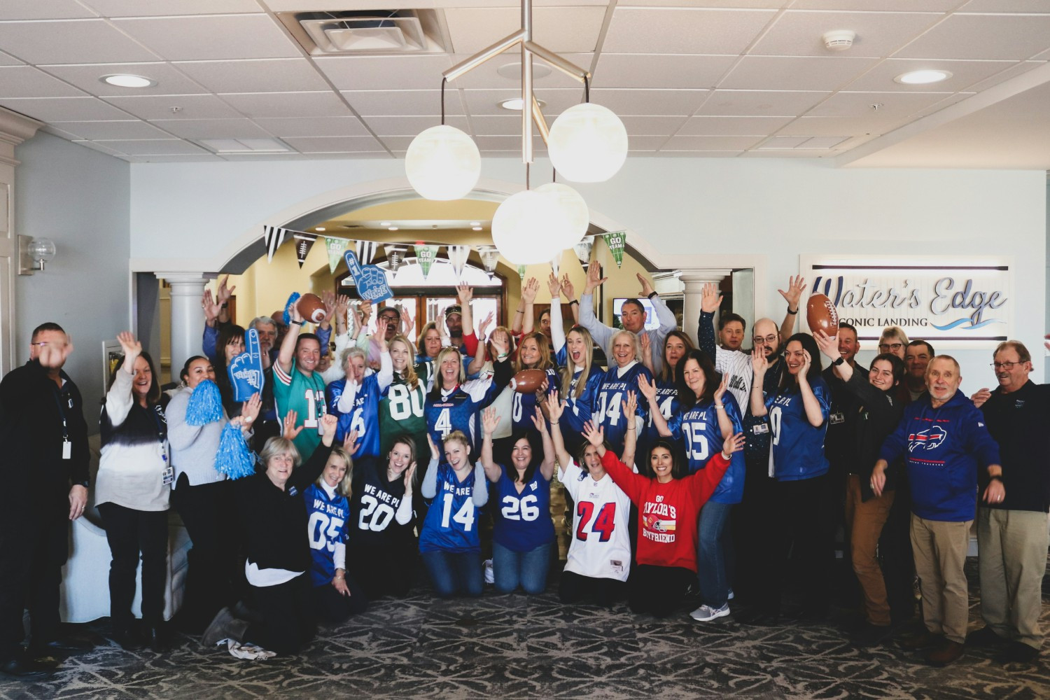 Team members having fun and wearing their sports jerseys in honor of Super Bowl Sunday.