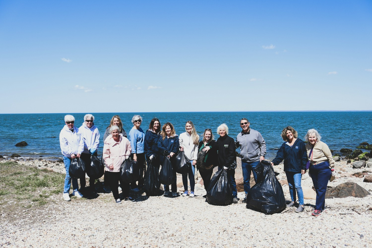 Team members and members joining forces and volunteering at our annual Earth Day beach clean-up.