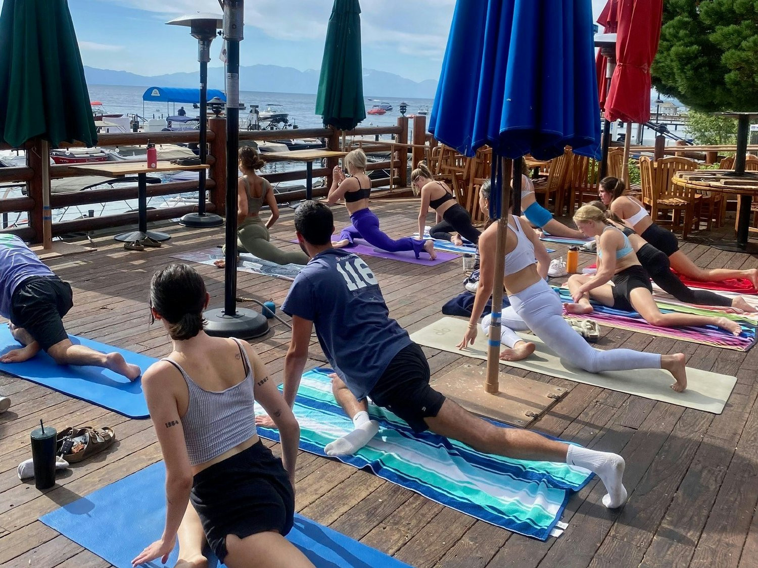 The T S wellness program in action! The team enjoys yoga by the lake.