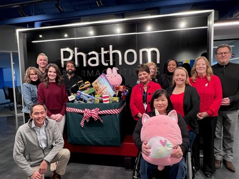 Members of the R&D team in Buffalo Grove, IL pose in front of their Toys for Tots collection box, an annual tradition.