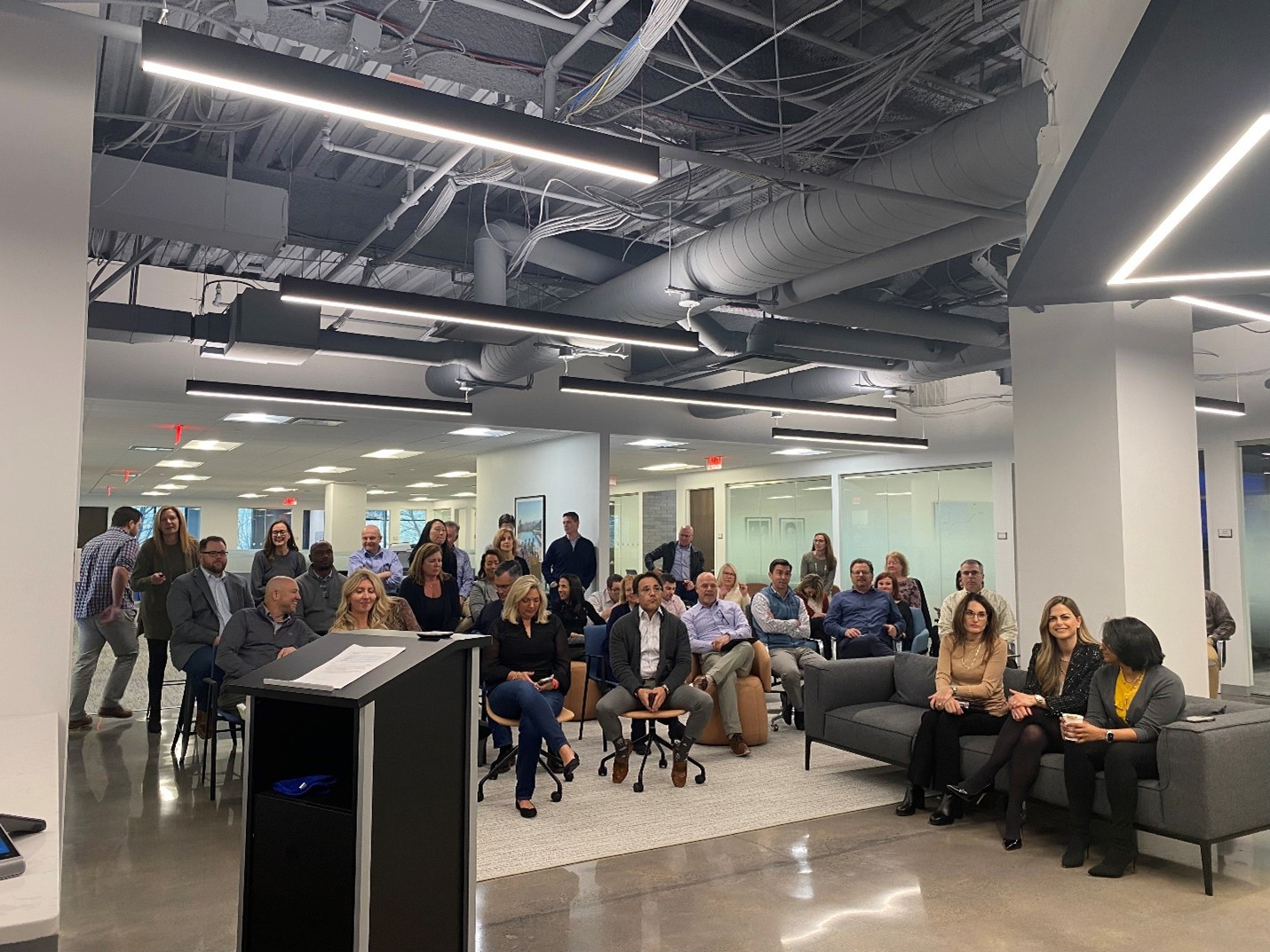 Employees gather at HQ for an internal Town Hall Meeting to discuss organizational updates and align on key goals.