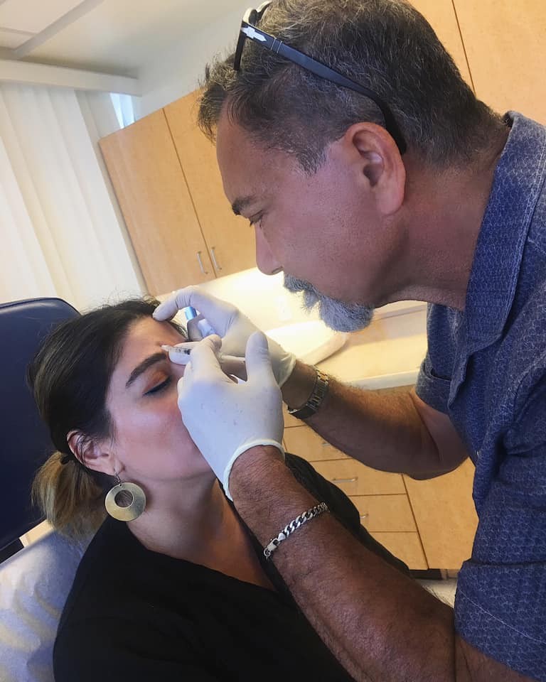 A Provider treating a Patient's forehead.