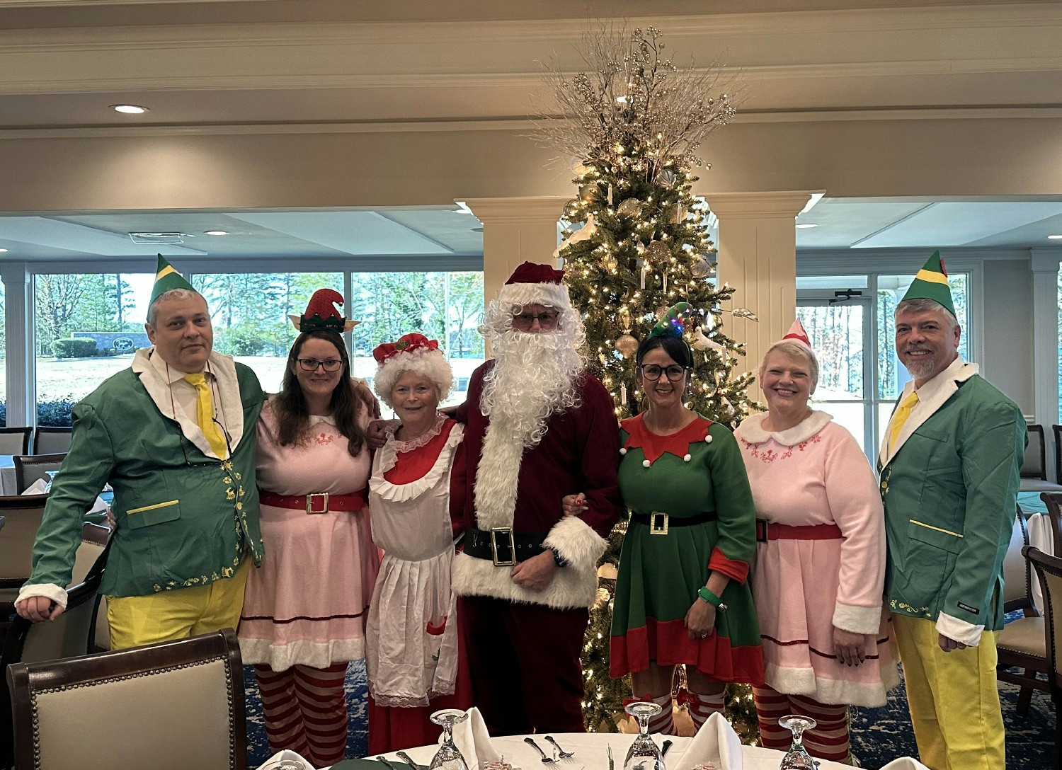 Santa, Mrs. Claus, & the Elves at our annual Christmas luncheon just before handing out hand written cards for all. 