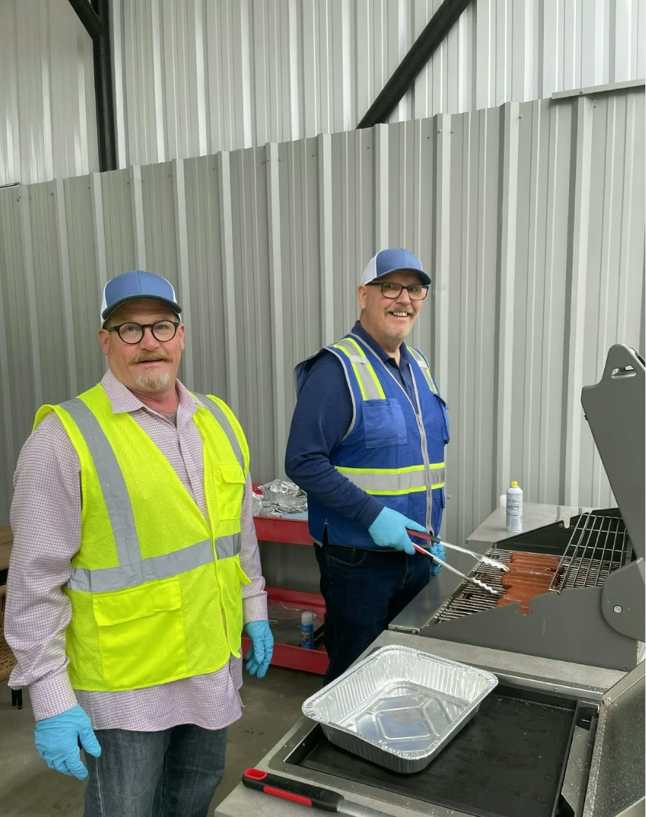 Mark Jones and Dave Stone grilling hot dogs onsite for our Quarterly All Hands Meting. 