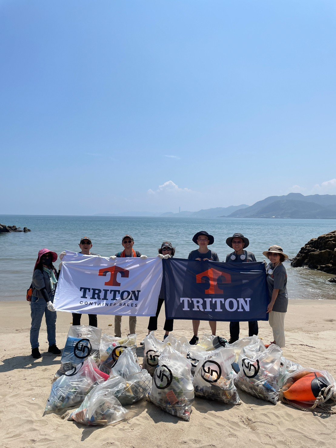 Triton Global team members at a beach clean-up event in Taipae