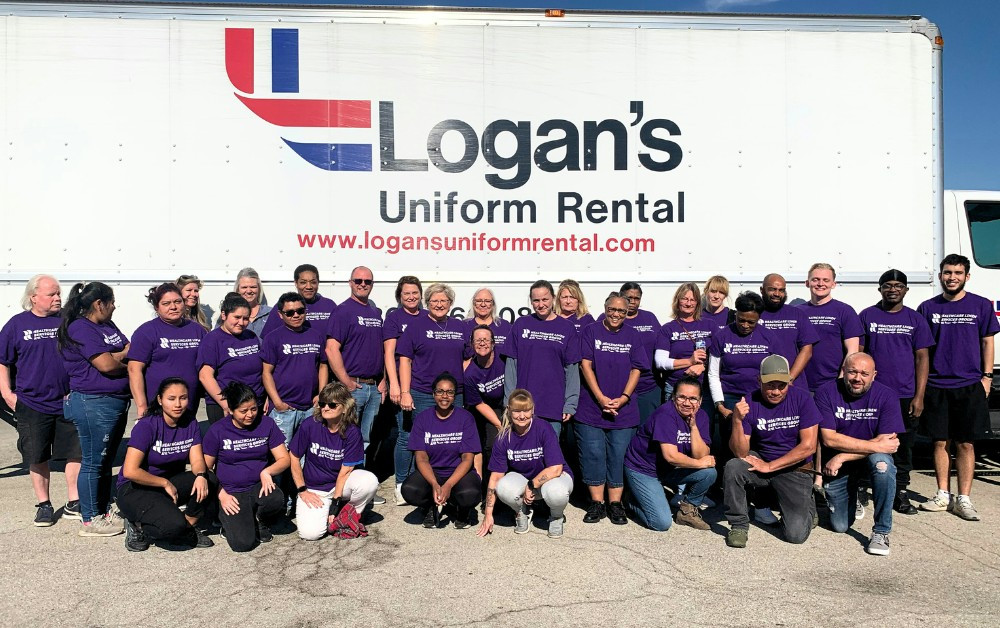 HLSG Logan's Uniform team posing with employee appreciation tshirts! 