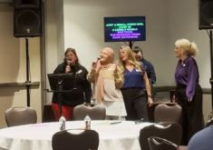 Sales team signing karaoke. 