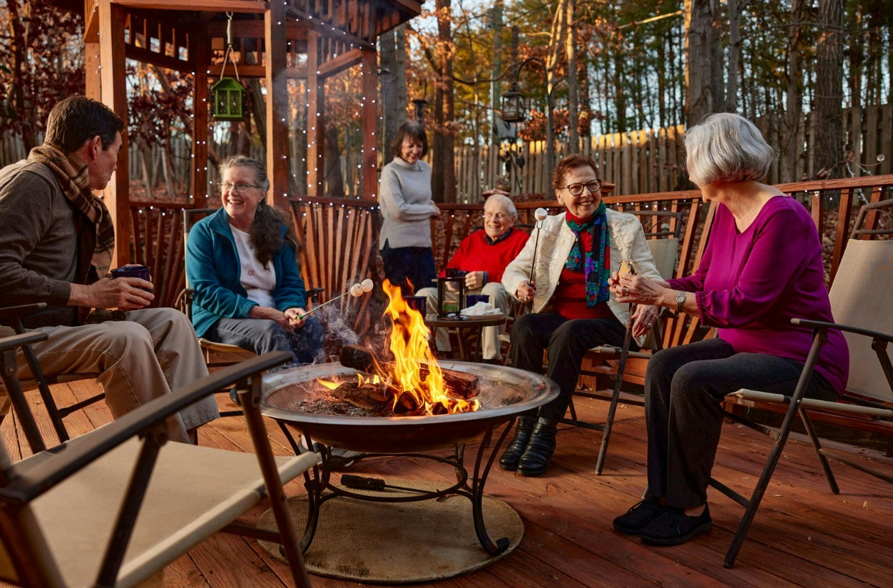 Residents at our Brookridge campus, enjoy social time with coffee over the fire pit 