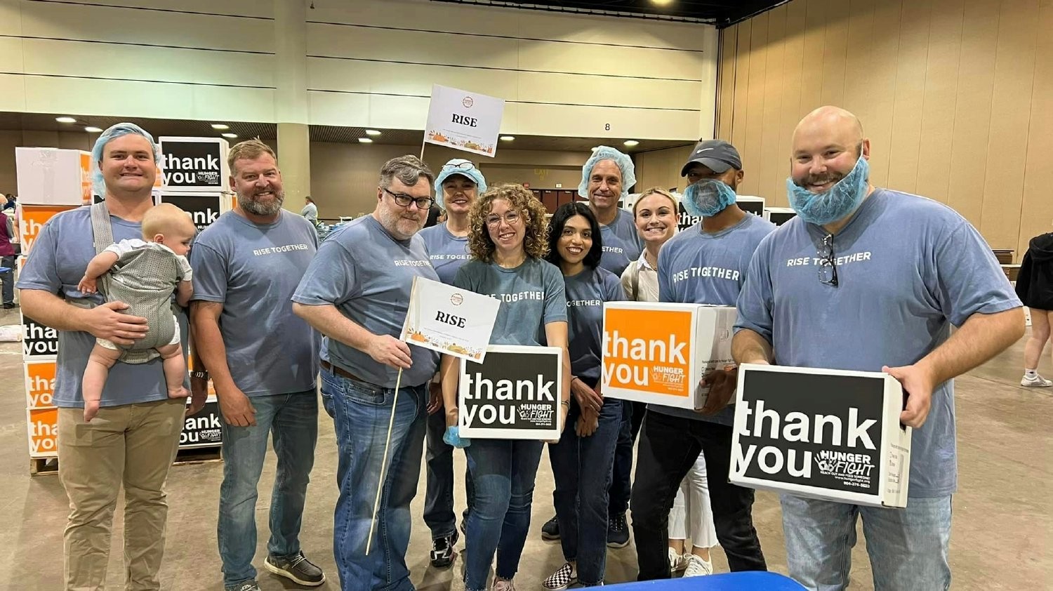 RISE team members packing ready-to-cook meals for Hunger Fight, to be distributed to local youth in North Florida.