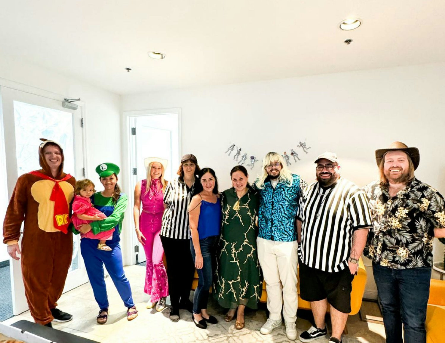 The team huddles for a Halloween costume contest at the office.