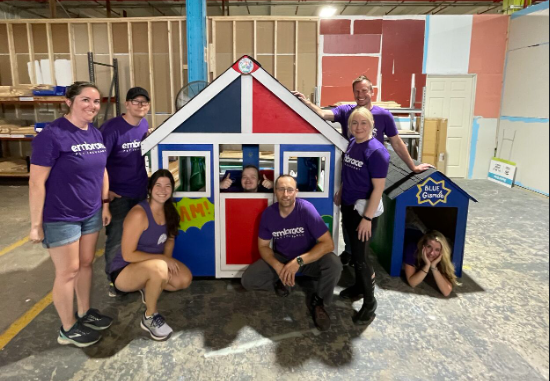 Marketing and IT team members volunteering to build playhouses with Habitat for Humanity