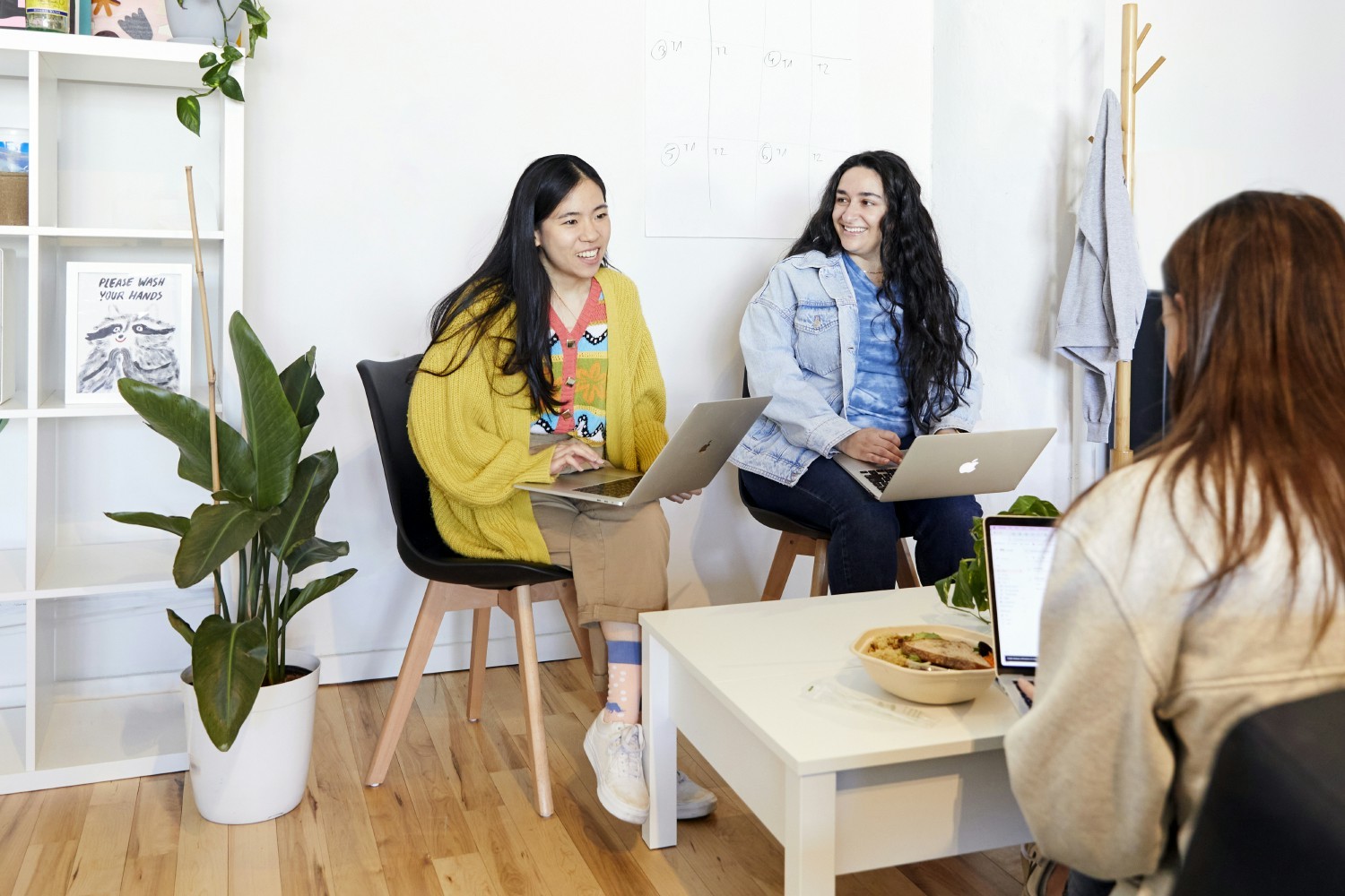 Team members gather for a meeting in one of our bright and sunny offices