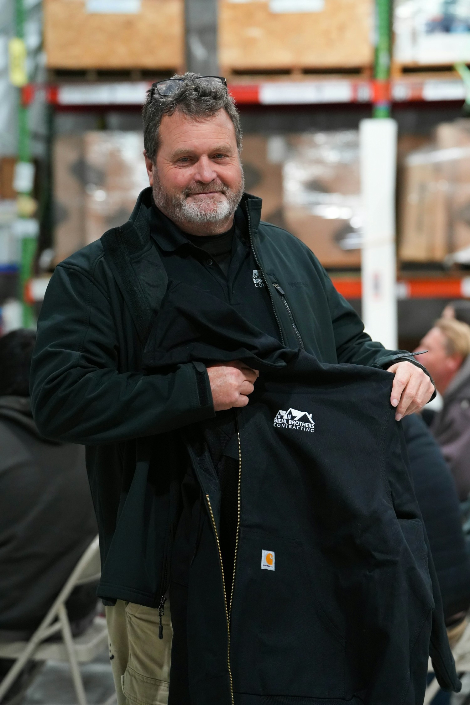 One of our production managers accepting the coats provided to our crew for christmas. 