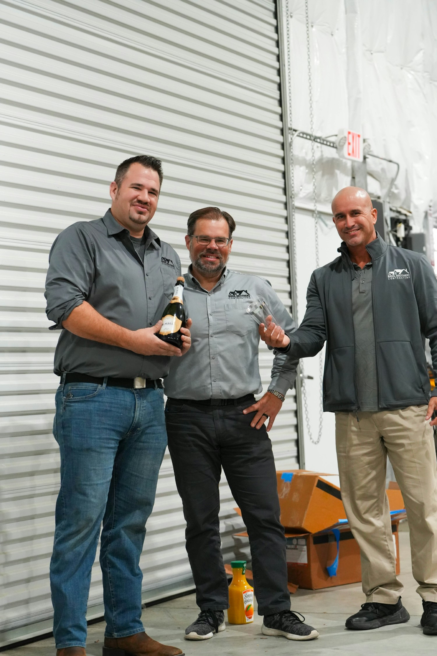 The owners Chase and Ryan Biehl with salesman Kelly celebrating being a great place to work 3 years in a row. 