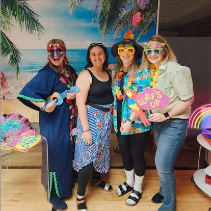 Next PR Colorado Springs team members dress up for a tropical-themed holiday party to celebrate the end of 2023. 