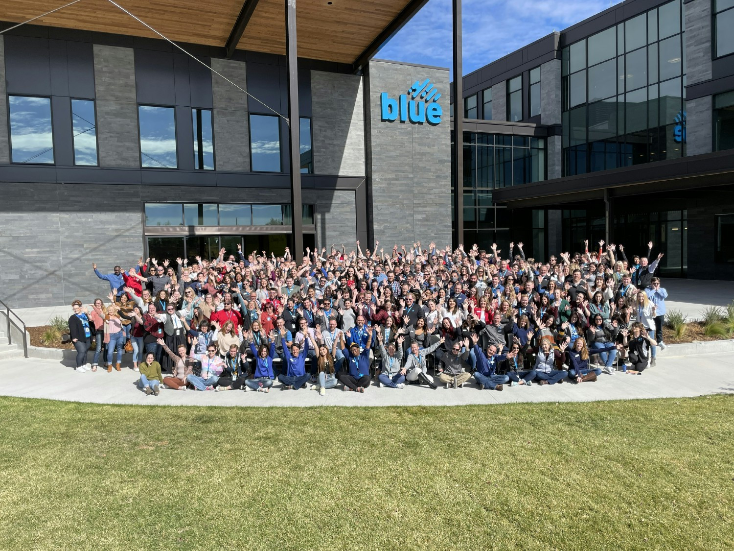 All employees in front of headquarters building.