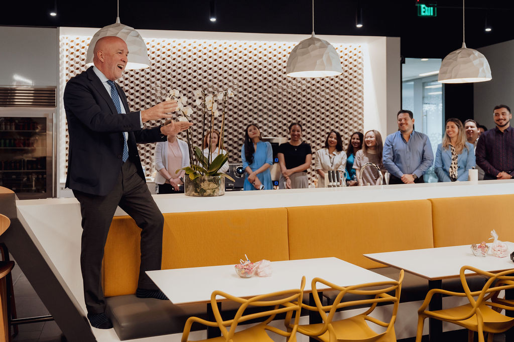 No microphone, no problem! CEO Nacho Torras gets elevated to address a full house during the new office ribbon cutting.