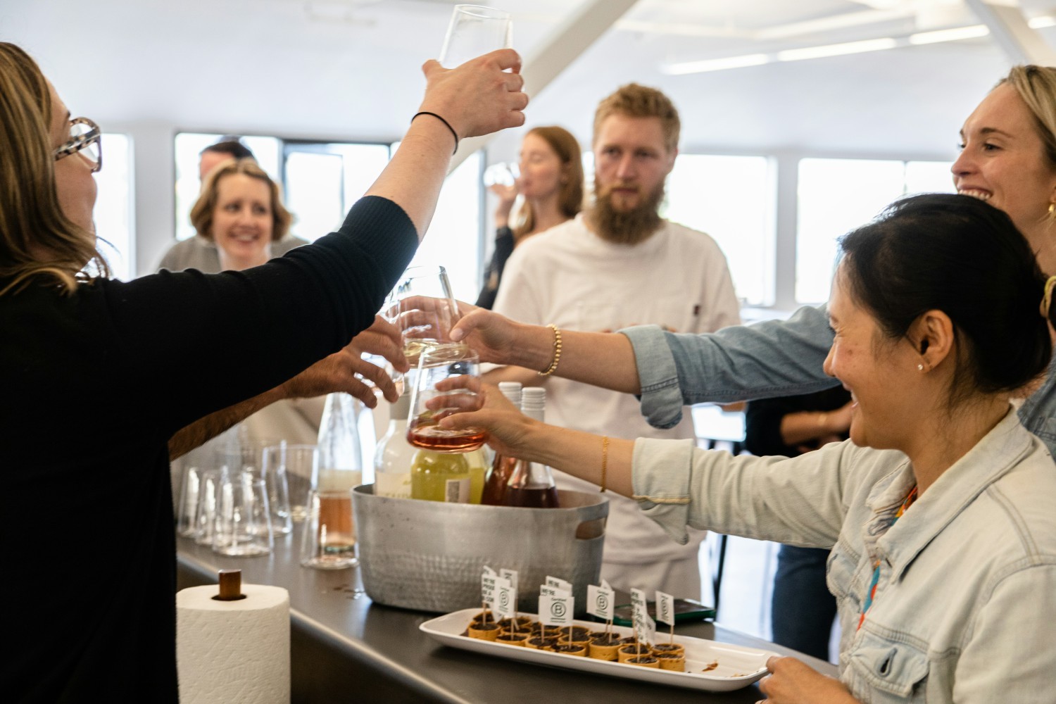 Part of our team raising a glass during a happy hour event to celebrate our successful certification as a BCorp!