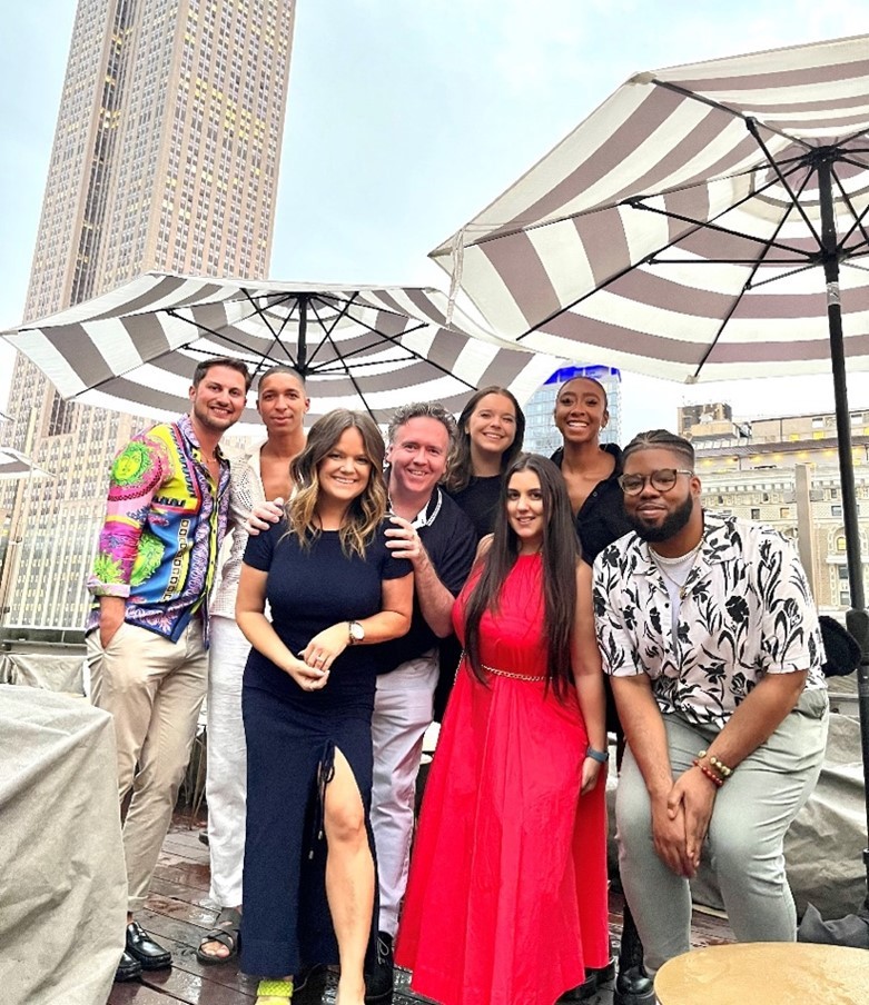 Capri Employee Resource Group members celebrate the start of summer on a NYC rooftop