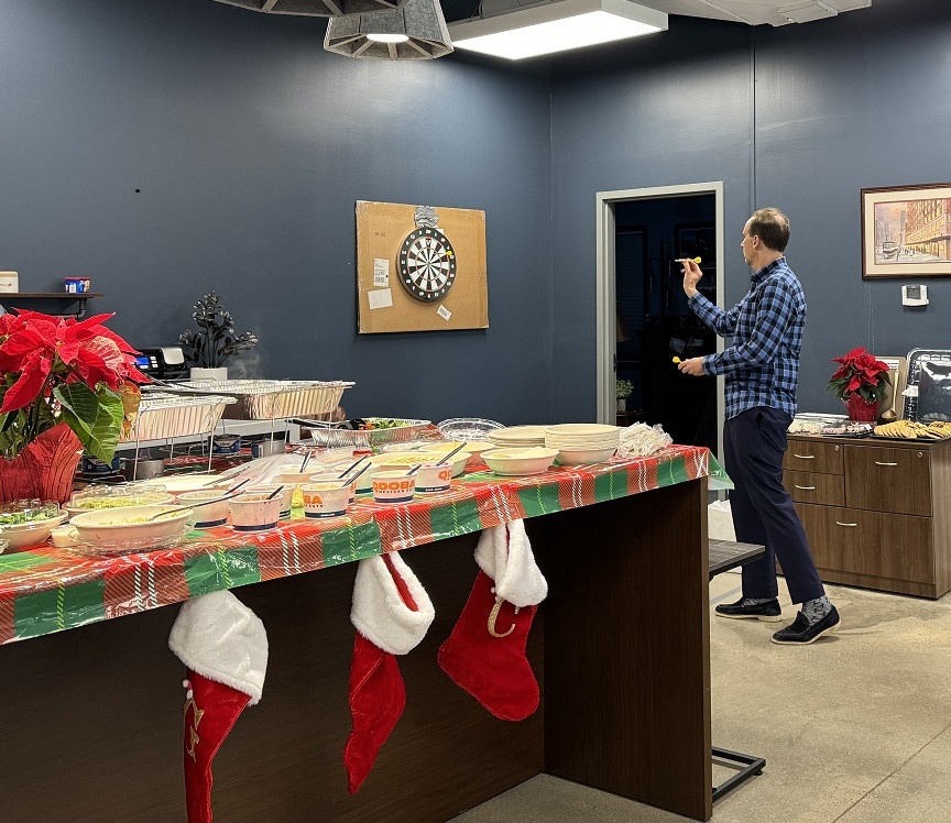 Our CEO throwing darts at our 2023 Xmas party, don't give up your day job!