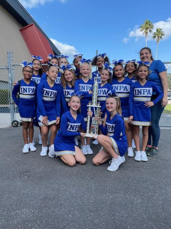 Innovation Prep. Academy cheerleaders in Wesley Chapel, FL, show off their trophy won in fierce competition.