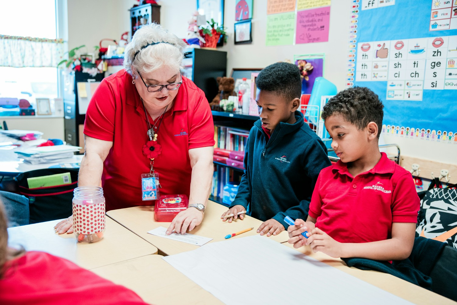 A teacher at Mevers School of Excellence in South Carolina, works with two students to help them develop strong minds.