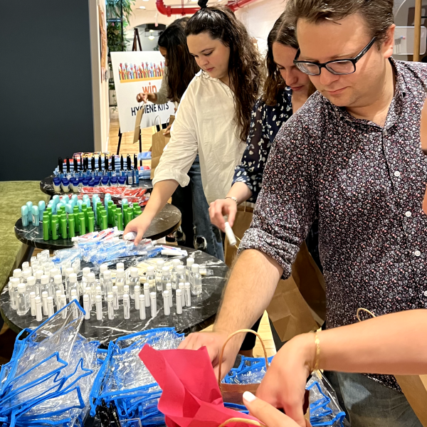 Lemonade Makers line up to help stuff backpacks during its annual Giveback.